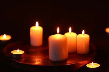 Beautiful burning candles on black background