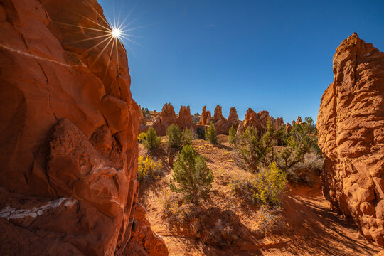 USA, Utah, Grand Staircase Escalante National Monument. Sunburst on rock pinnacle hoodoo formations.