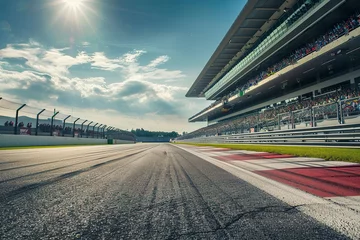  A race track with a large crowd of people watching the race. © Mnur