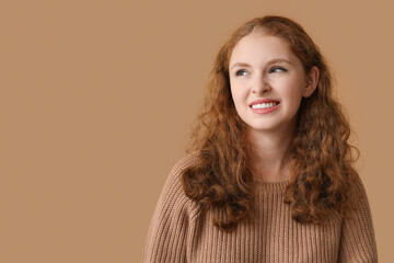 Fototapeta premium Portrait of ashamed young woman on brown background