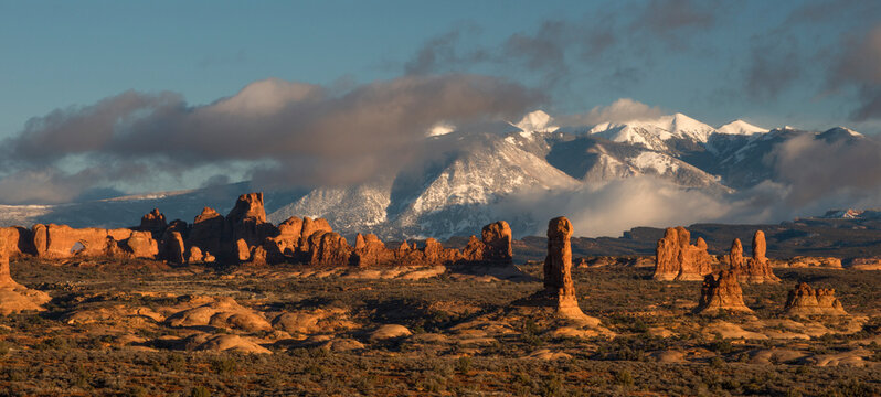 Usa, Utah, Arches National Park. Sunset on the Windows Section with La Sal Mountain range and clouds.