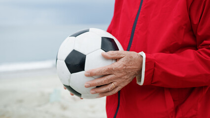 Man Holding A Soccer Ball In His Hands 