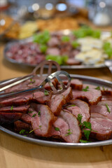 Slices of baked meat on a metal tray.
