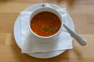Tomato soup in a bowl with a spoon.