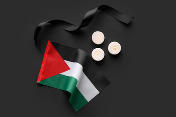Flag of Palestine, ribbon and burning candles on black background