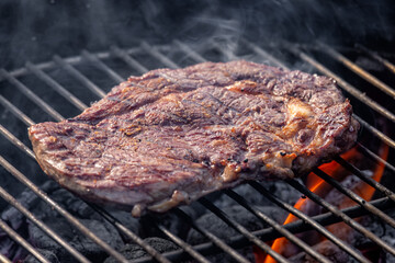 steak grilling on charcoal grill