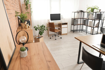 Chest of drawers, chair and workplace in modern office