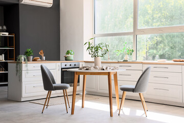 Dining table with decor in interior of kitchen