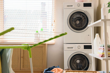 Interior of laundry room with dryer and washing machines