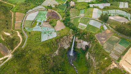 A beautiful waterfall among farmland. Sipiso Piso falls. Sumatra, Indonesia.