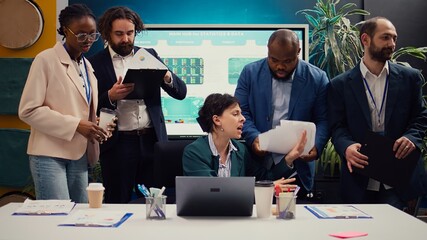 Irritated difficult boss getting angry at her employees team after not finishing the project before...