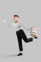 Running female pantomimist with bag on grey background