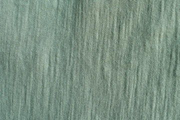 A closeup view of green textured cotton fabric.