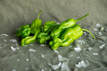 Group of green peppers on an olive green background.