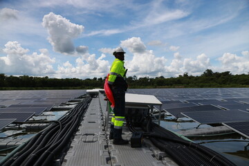 Floating Solar panel farm, black male energy engineer and construction inspecting, renewable energy and installation check with the contractor, eco-friendly and sustainable. Solar energy, sustainable 