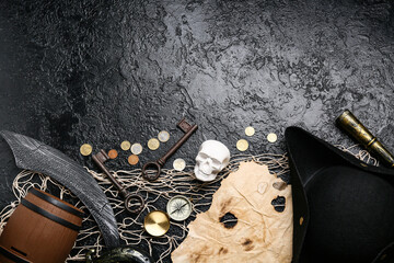 Pirate hat with different items on black background