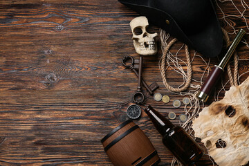 Pirate's items on wooden background, top view