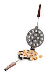 Baking form with tasty walnut shaped cookies on white background