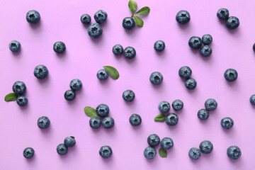 Many ripe blueberry on lilac background