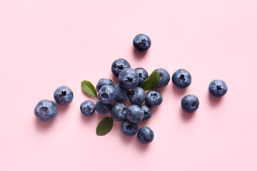 Pile of fresh ripe blueberry on pink background