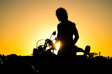 silhouette of a biker with sunset