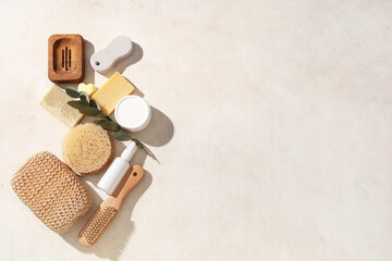 Composition with bath supplies, cosmetic products and eucalyptus branch on light background