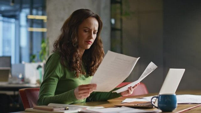 Pensive woman looking papers working office closeup. Manager analysing documents