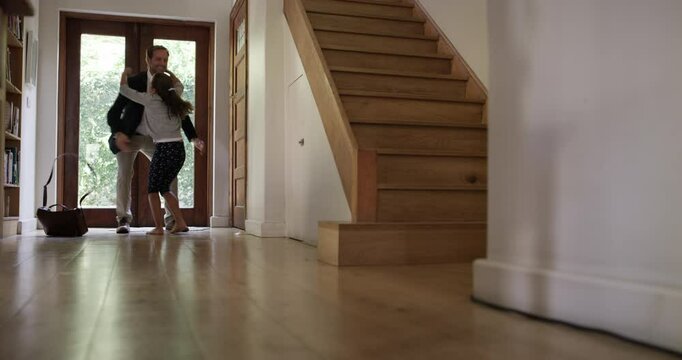 Man, arrive and home or running child in hallway for hello, hug love after work. Male person, girl at front door embrace dad for youth development or parent greeting for happy care, excited to bond