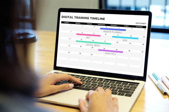Woman hands typing laptop computer with digital trainting timeline schedule on screen at office background, business technology, smart office, online training, remote work concept