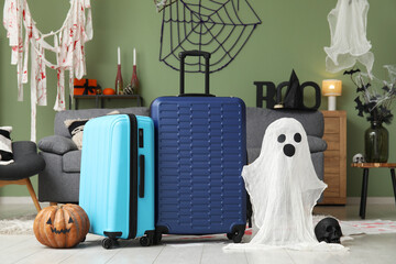 Suitcases with Halloween decor in living room