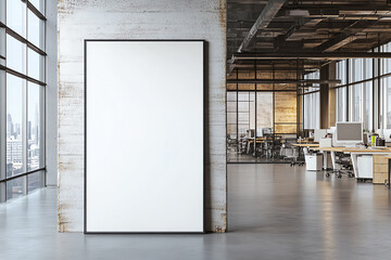 Modern office interior with blank vertical poster on concrete wall, large windows, and open-plan workstations. Contemporary corporate design.