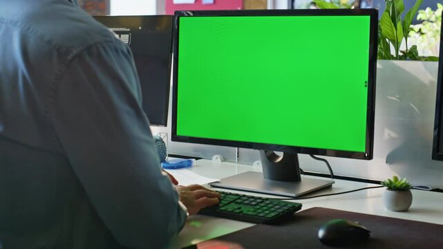Unknown freelancer working green screen computer in modern workplace closeup