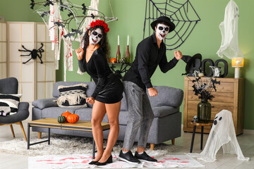 Young couple dressed for Halloween dancing at home