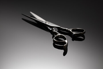 Hair cutting scissors on a dark background