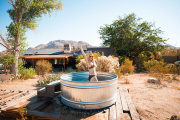 Pretty blonde woman posing in a cowboy bath on vacation. Joshua Tree, California