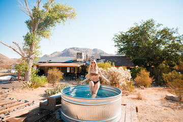Pretty girl posing in a cowboy bath on vacation. Joshua Tree, California