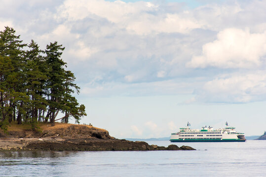 USA, Washington State, San Juan Islands. Washington State ferry rounds top of San Juan Island from Sidney Canada