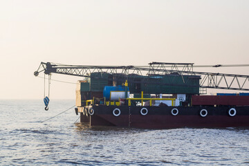 Tugboat with chain at anchor
