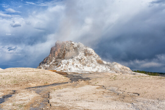 USA, Wyoming, Yellowstone National Park. Lower Geyser Basin, White Dome Geyser begins its eruption.