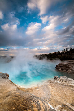 Usa, Wyoming, Yellowstone National Park. Clouds and steam converging at Excelsior Geyser.
