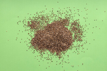 Heap of organic fresh chia seeds - Salvia hispanica. green color background