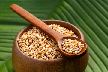 Amaranthus - Bowl and spoon filled with amaranth seed pops.