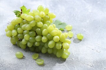 Fresh ripe grapes on grey table, closeup