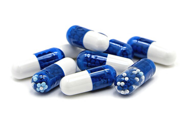 blue and white antibiotic capsule pills on a white background