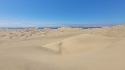 Sand dunes desert city Peru