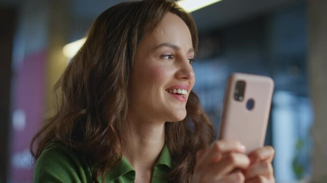 Smiling woman staring smartphone in office closeup. Businesswoman enjoying break