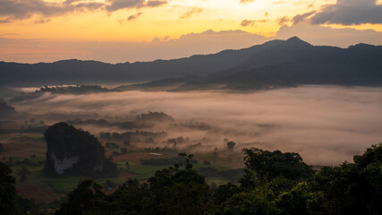 Dramatic sunset over mountain landscape. Beautiful landscape foggy hills twilight time. Blue golden sky sunrise dramatic beautiful landscape mountain. Dawn sky gold dusk time cloudscape with sunlight