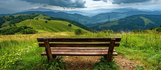 Fototapeta premium Wooden Bench For Sitting With Nice View To Hills Landscape Scenery