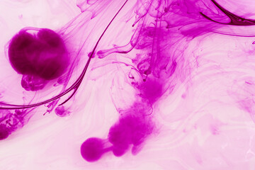 Abstract background of pink and purple ink splashes on a white background
