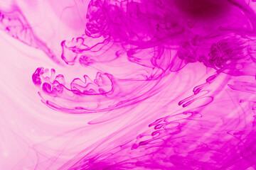 abstract background of pink ink swirling on white background